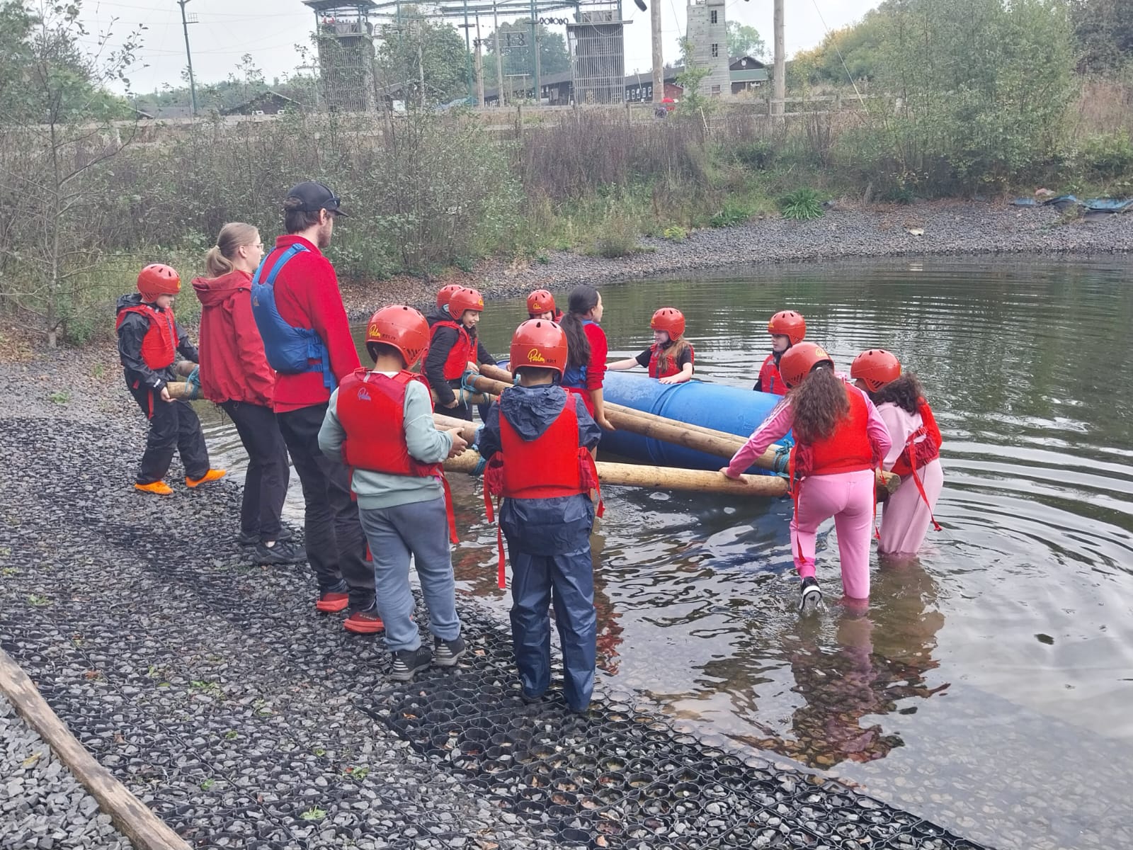 Some children moving raft into the water
