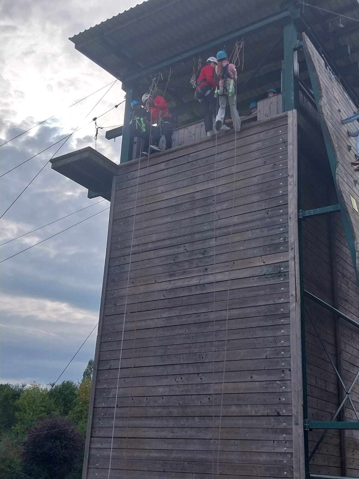 Two starting to come down abseiling wall