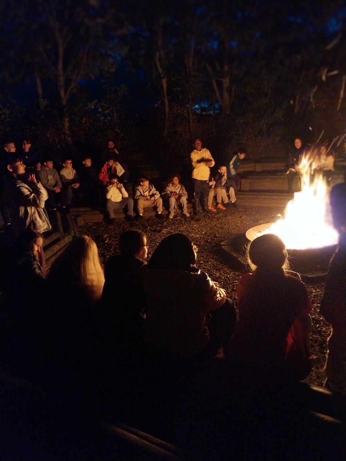 Group of children sat around a campfire