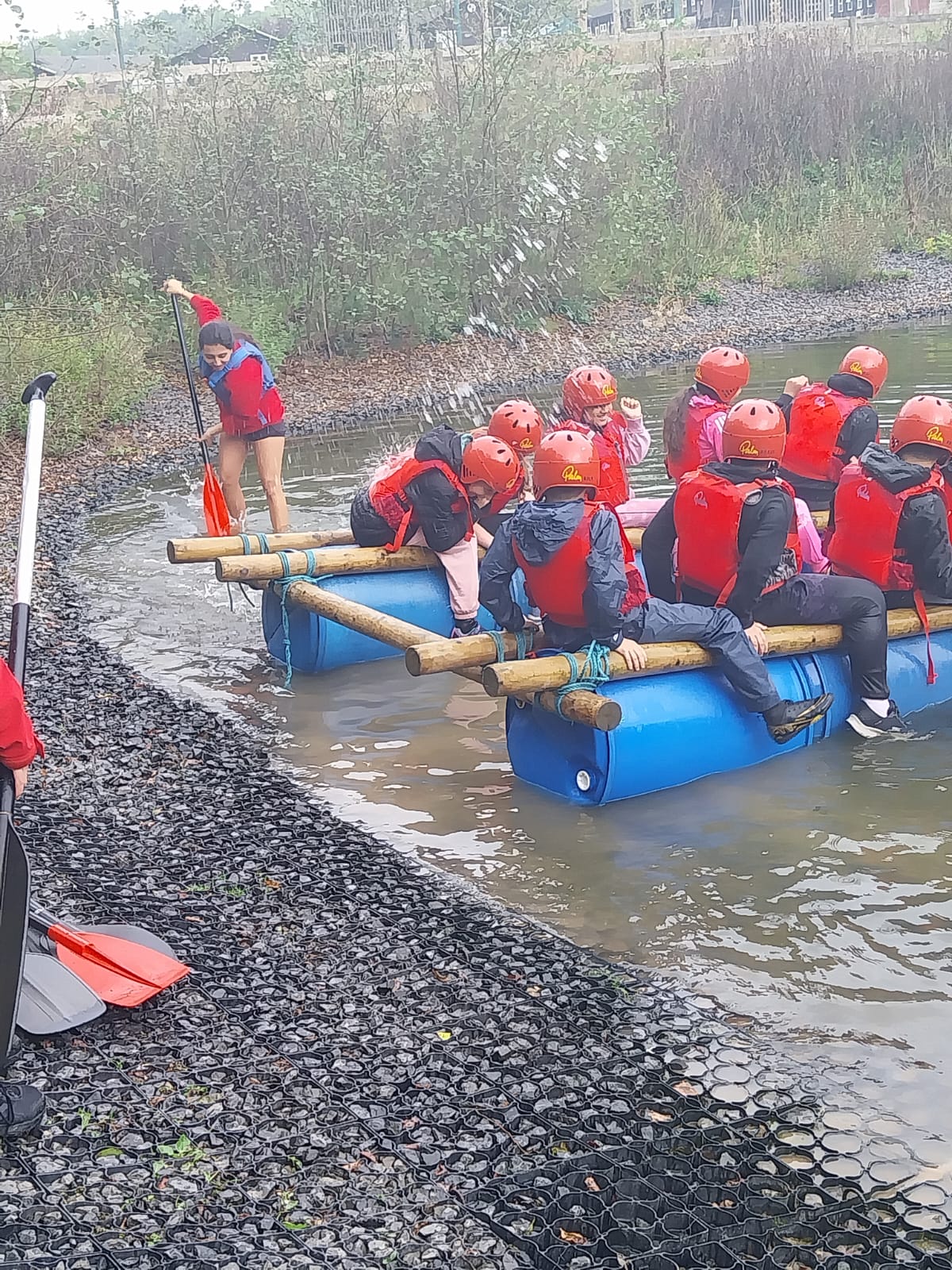 Some children moving raft into the water