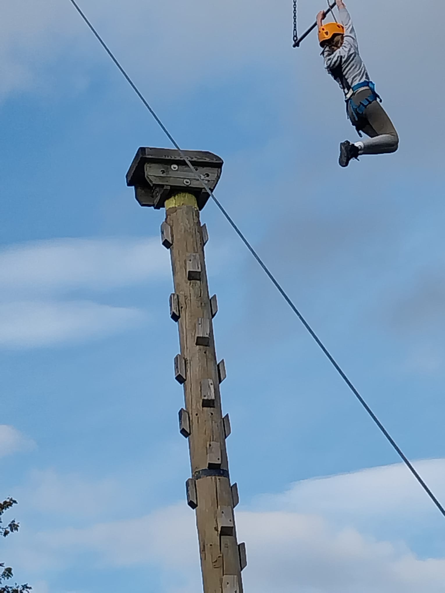Girl grabbing leap of faith bar after jumping off