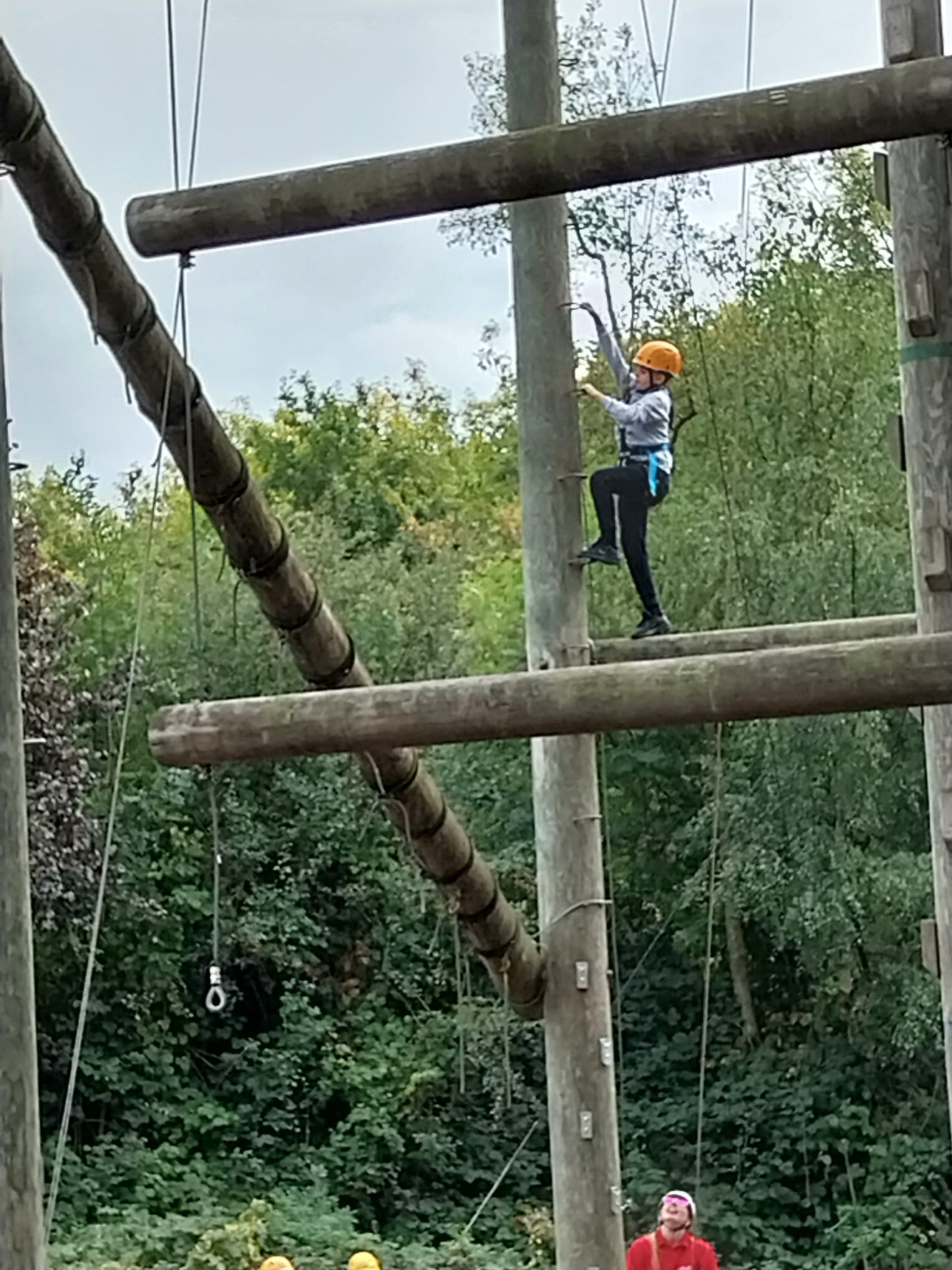 Child climbing up leap of faith pole