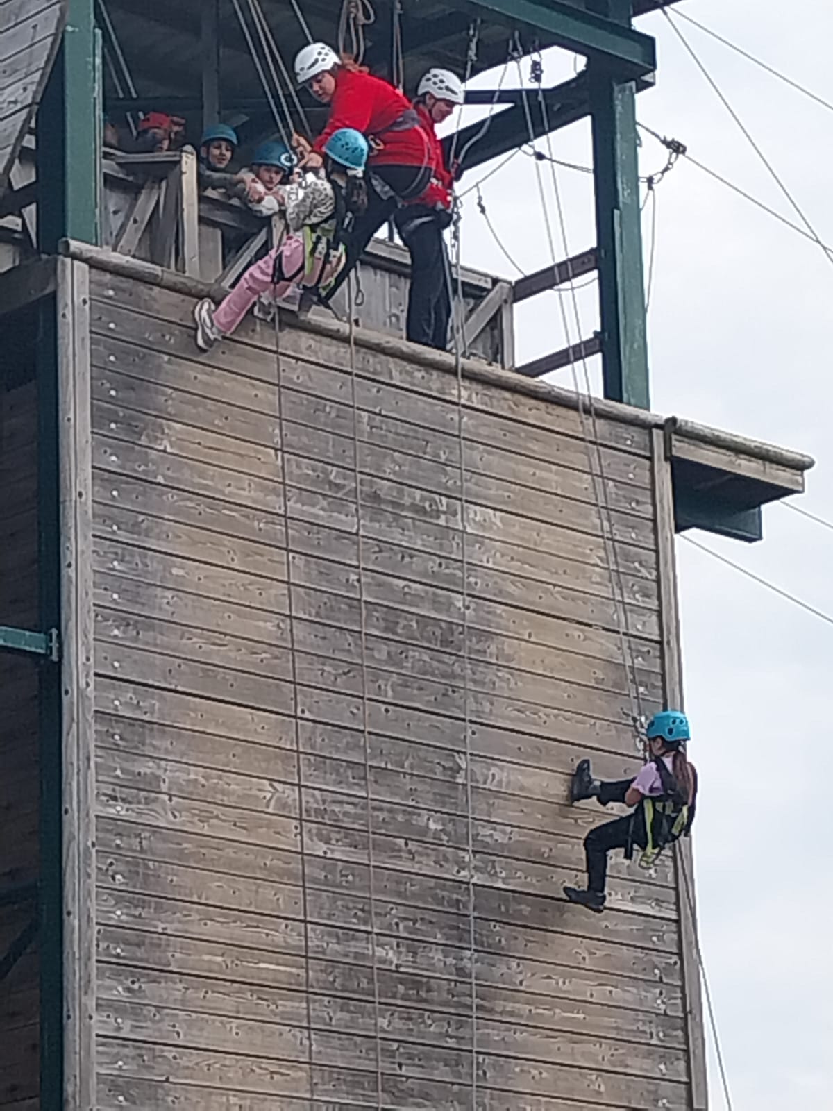 Two starting to come down abseiling wall