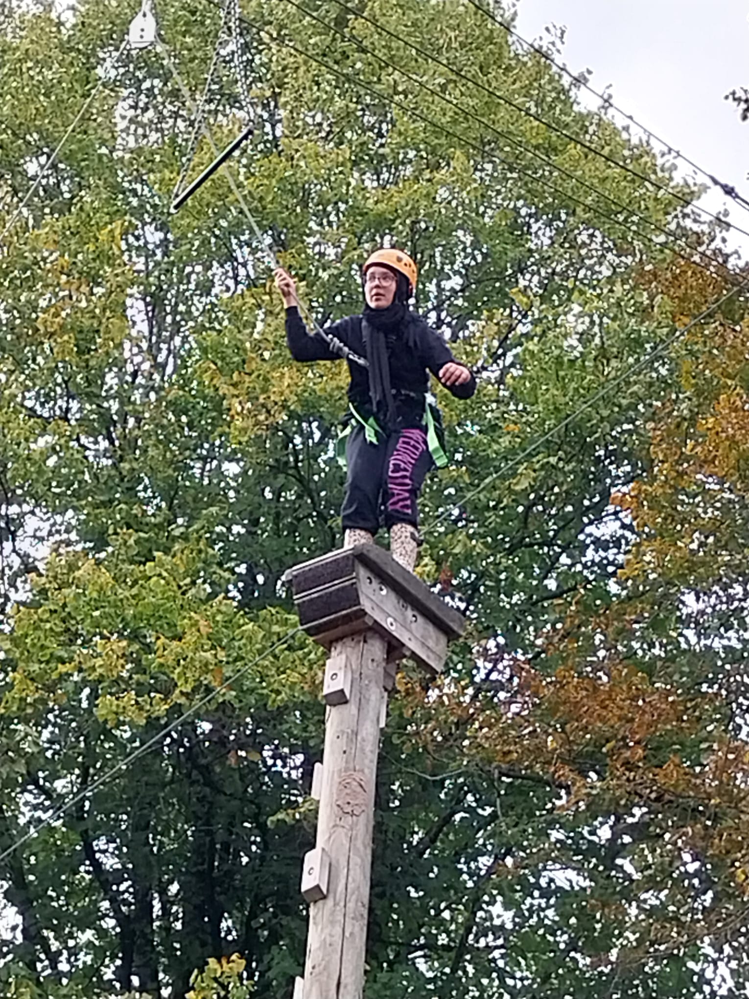 Girl about to jump off leap of faith pole