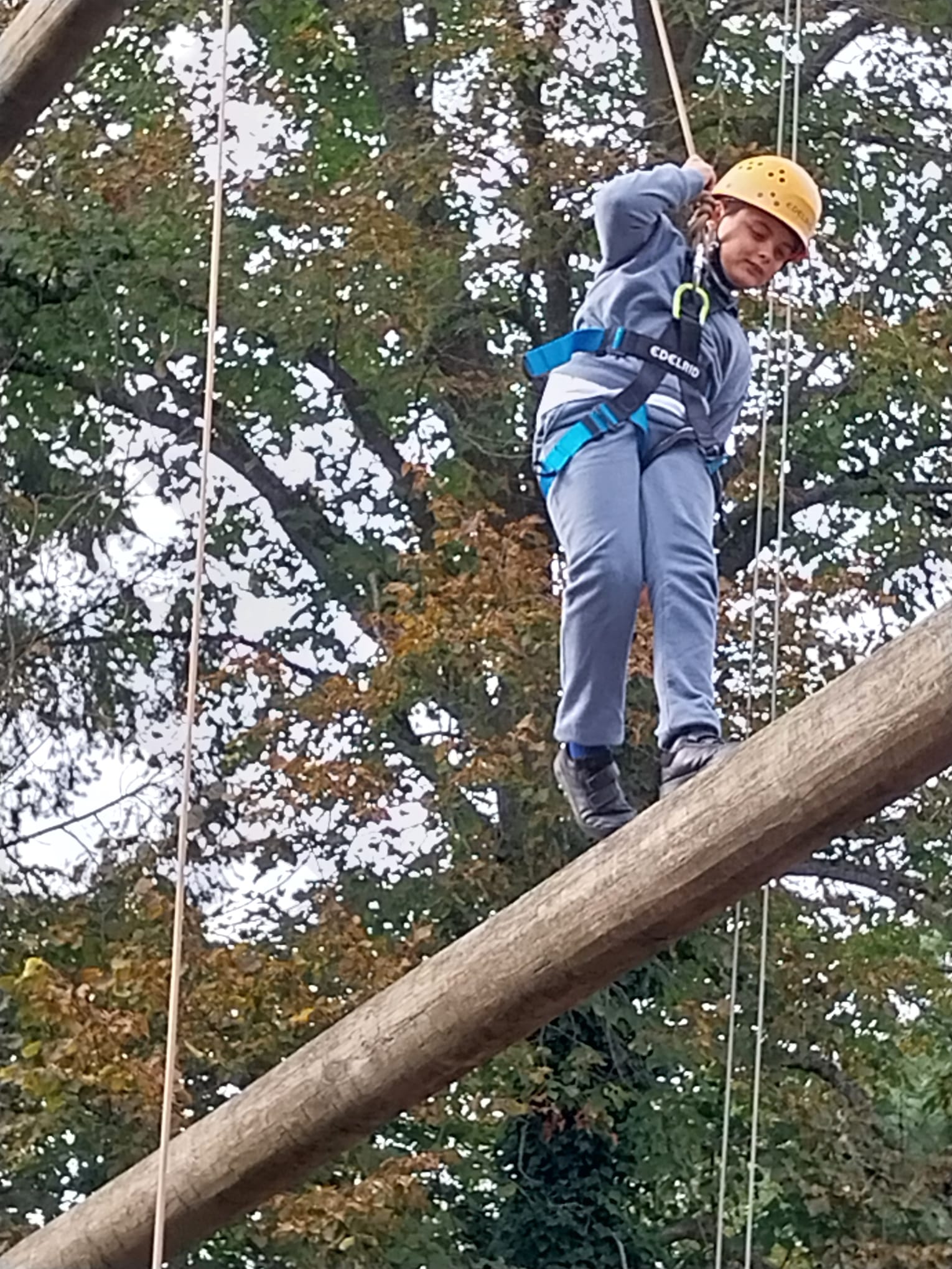 Boy walking along wooden beam 10 meters in the air.