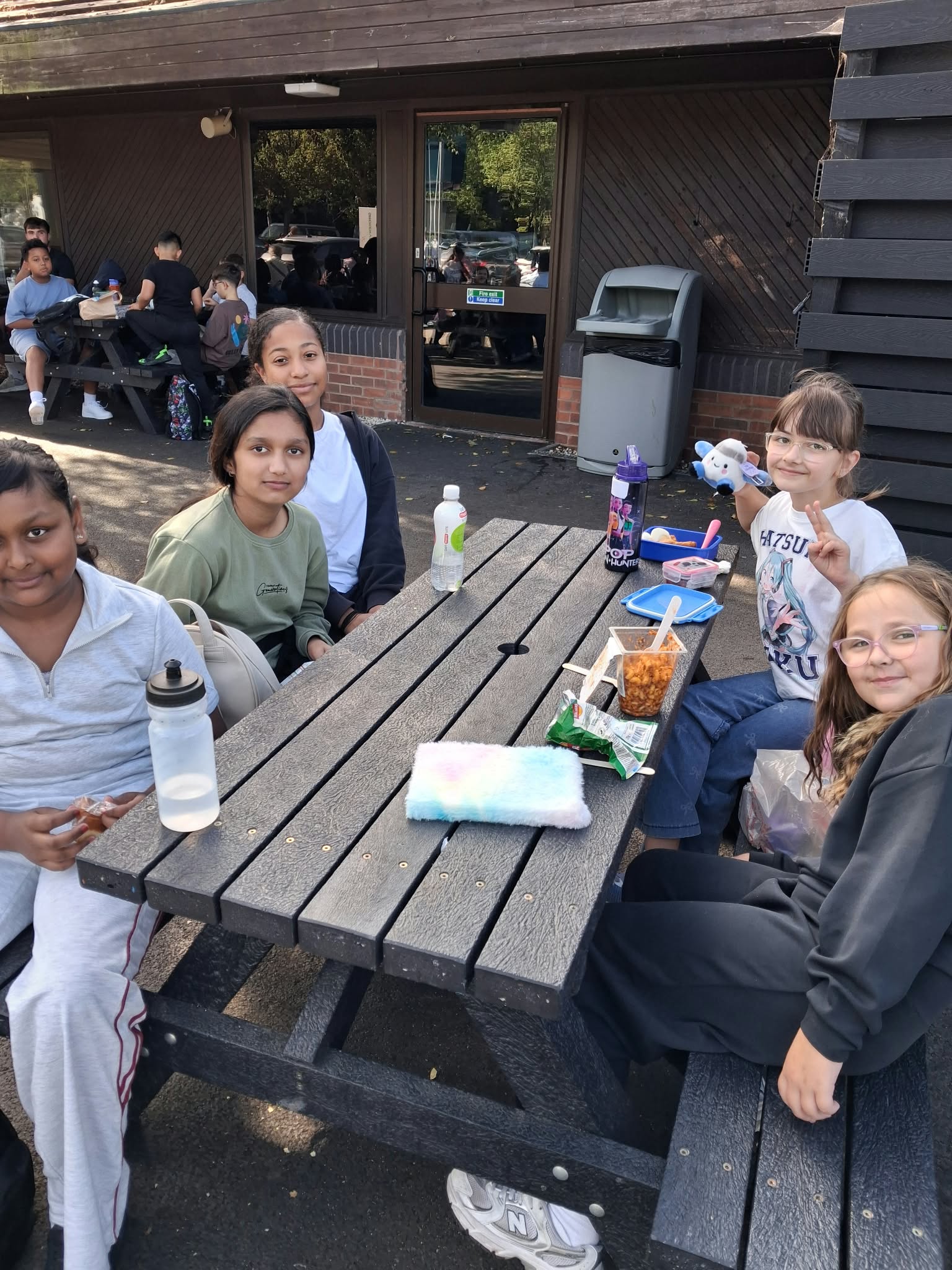 Year 5 & 6 children sat around a table eating lunch