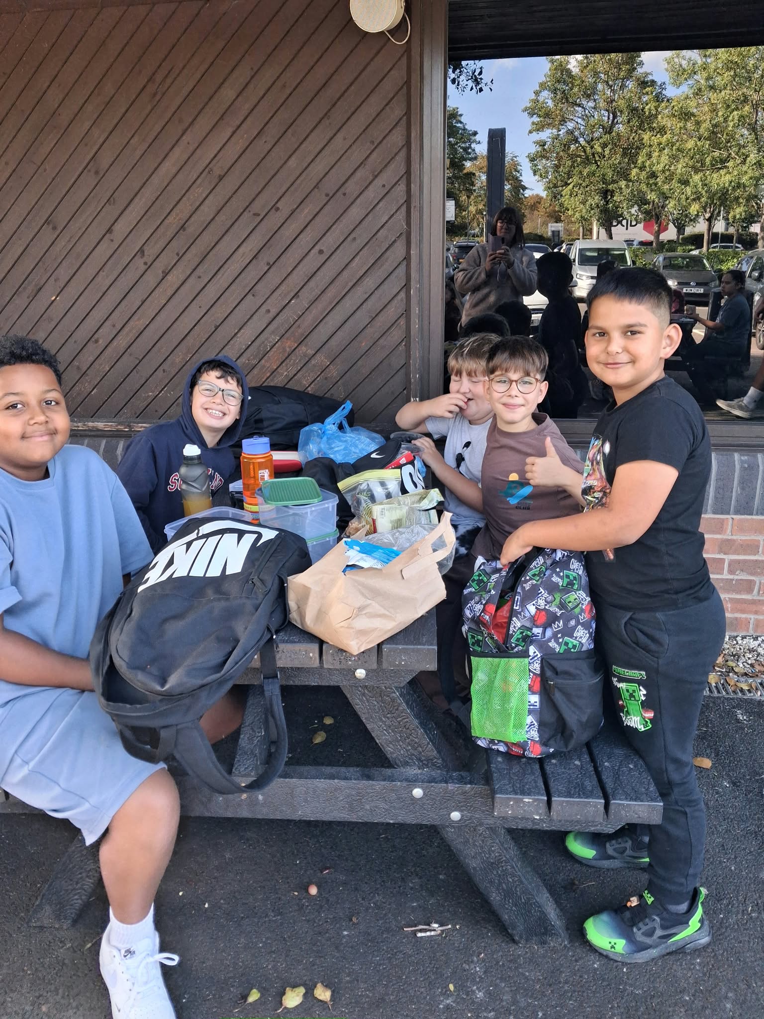 Year 5 & 6 children sat around a table eating lunch
