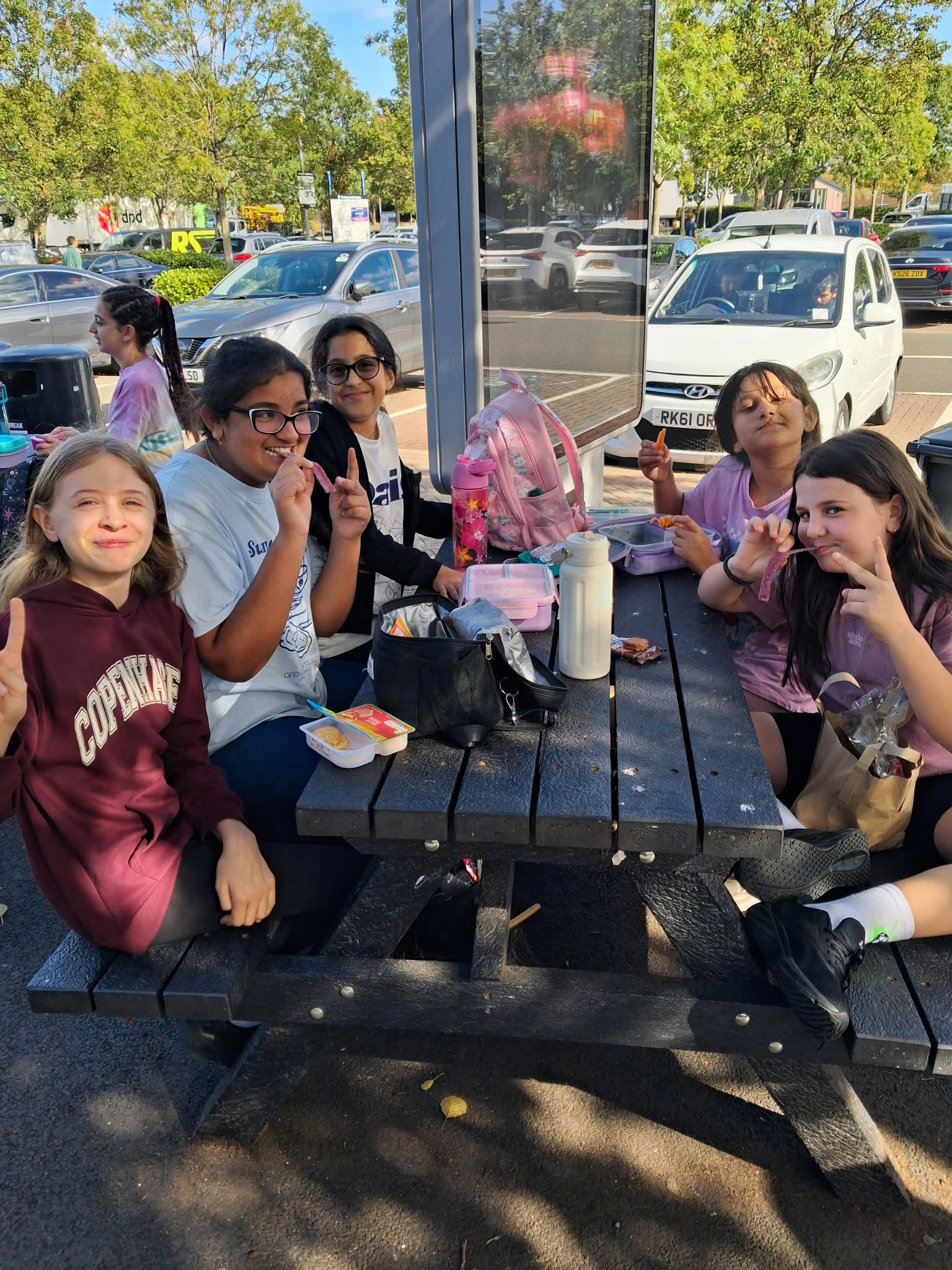 Year 5 & 6 children sat around a table eating lunch