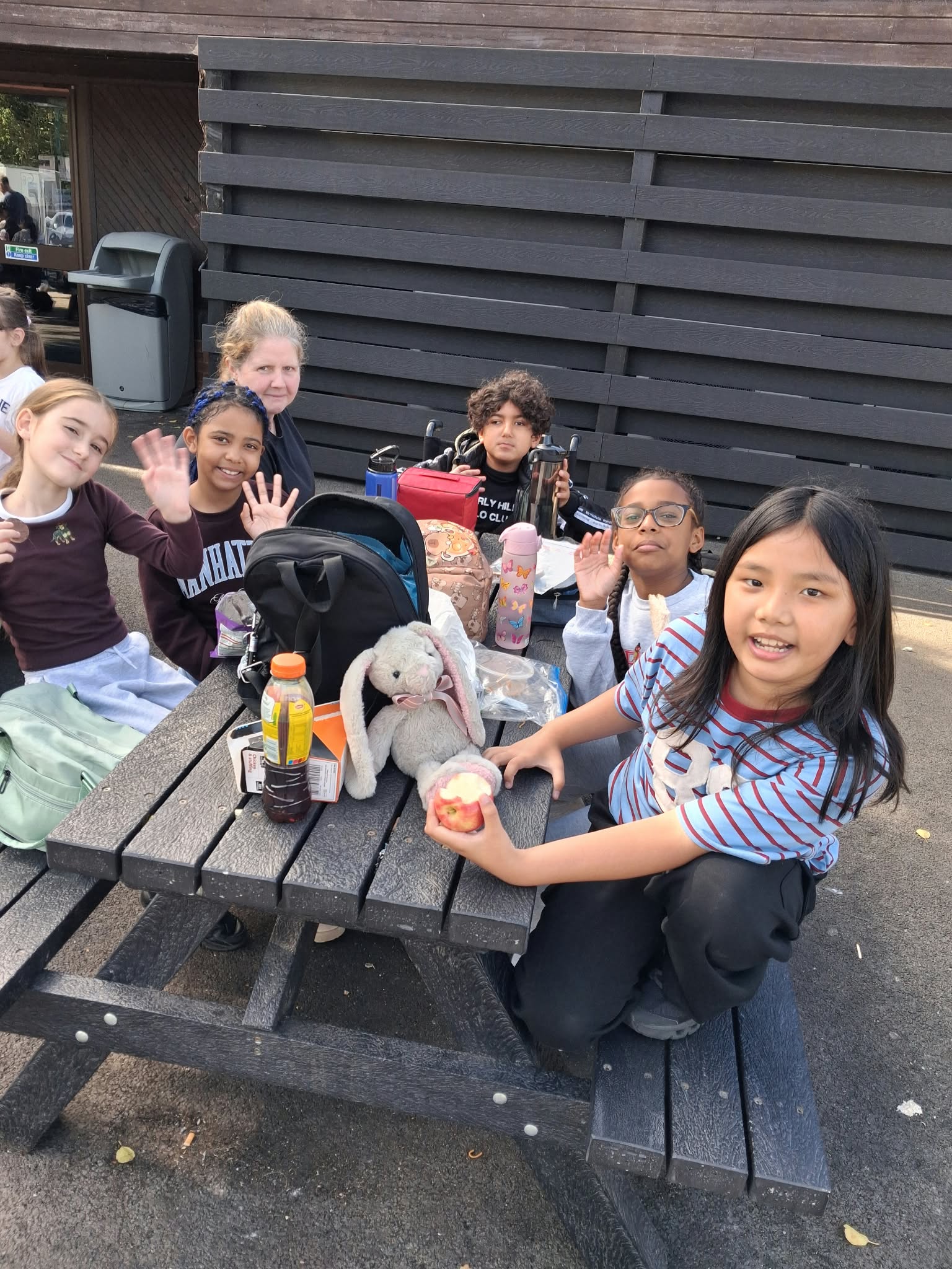 Year 5 & 6 children sat around a table eating lunch